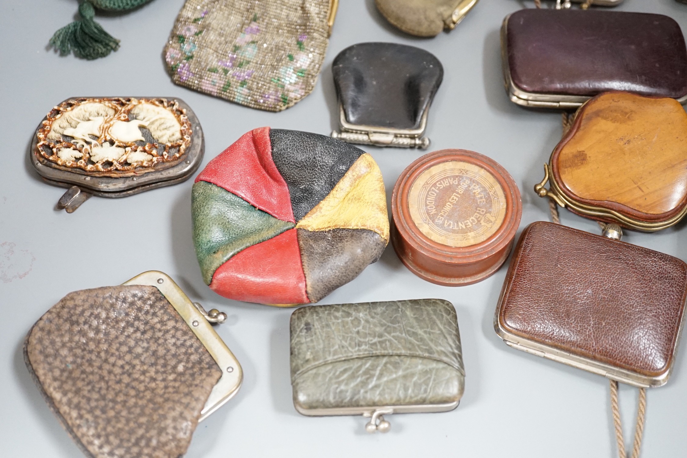 A collection of mostly Grand Tour, wooden souvenir purses and other 19th and 20th century leather and fur purses